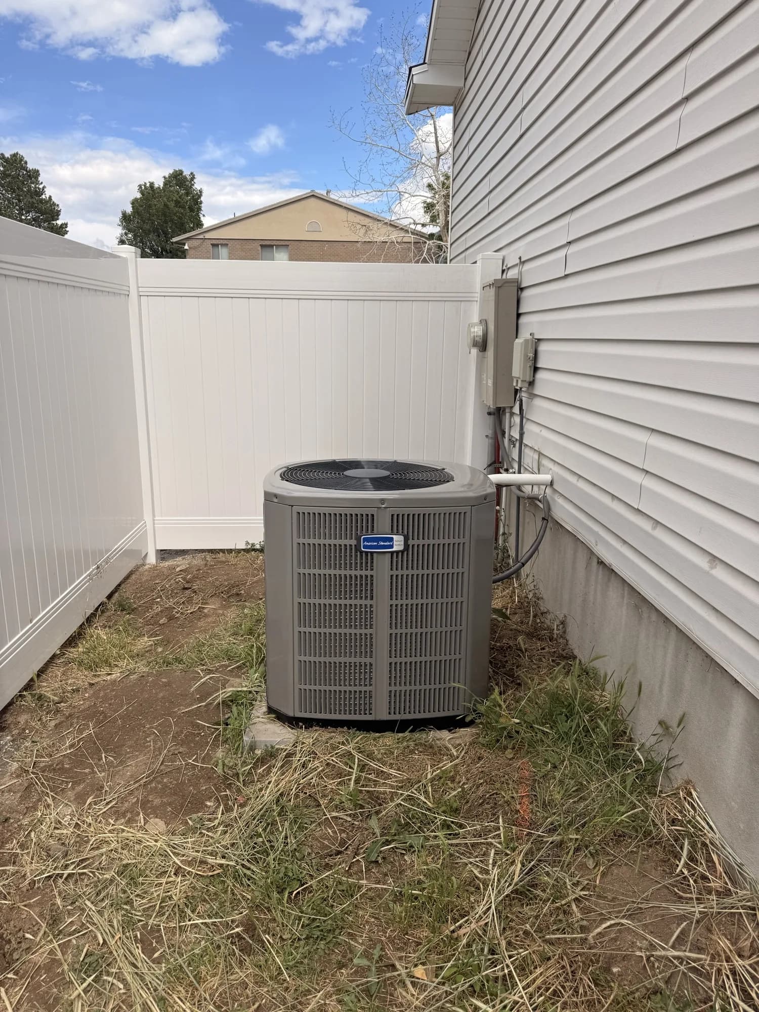 American Standard condenser installed beside a Salt Lake Valley home
