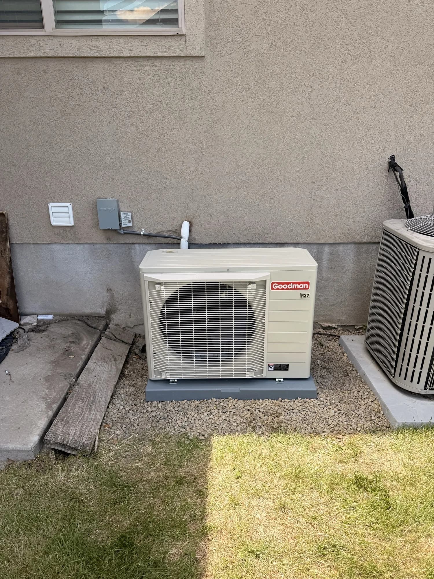 Side-discharge heat pump set level on a pad, wired and finished